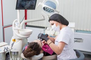 Jeune femelle patient avec jolie sourire examiner dentaire inspection à dentiste clinique. en bonne santé les dents et médecine, stomatologie concept photo