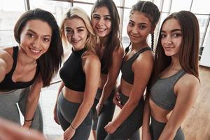 unité des amis. selfie de cinq filles satisfaites après l'exercice du groupe. jeunes femmes modernes photo