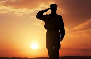 ai généré silhouette de une soldat salue à le coucher du soleil photo