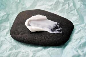 une diffamer de blanc crème sur une noir pierre. photo
