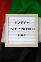 texte content indépendance journée sur Contexte agitant drapeau de Émirats arabes unis. nationale vacances de uni arabe émirats. commémoration journée musulman arabe vacances. Dubai fête photo