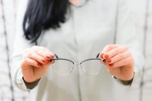 fermer de optométriste, opticien donnant des lunettes à essayer. photo