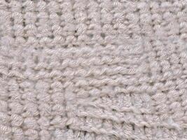 Contexte texture de une tricoté en tissu photo