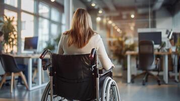 ai généré arrière vue de une femme sur fauteuil roulant travail sur portable dans un bureau, collègues. photo