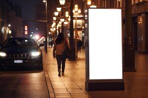 ai généré Vide mupi panneau d'affichage maquette sur trottoir à nuit avec bâtiment et route photo