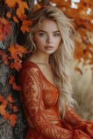 ai généré magnifique blond femme dans rouge orange robe posant par arbre avec coloré feuilles photo