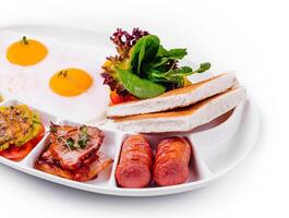 Anglais petit déjeuner avec saucisses, bacon, et pain grillé photo