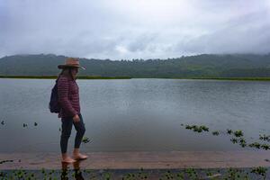 voyageur femme des promenades le long de le rive de le oconal lagune dans le jungle de Pérou. photo