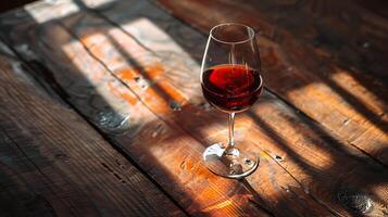 ai généré rouge du vin brille dans doux lumière sur rustique table photo