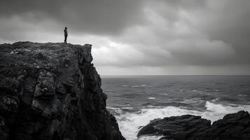 ai généré solitaire figure embrasse tranquille réflexion au milieu de robuste falaises et sauvage mer baigné dans vibrant le coucher du soleil lueur photo