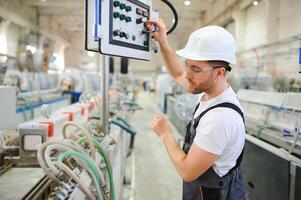 usine ouvrier. homme travail sur le production ligne photo