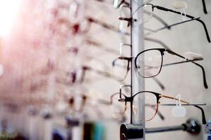 beaucoup des lunettes sur une rester. vitrine avec des lunettes dans moderne ophtalmique magasin. fermer. photo