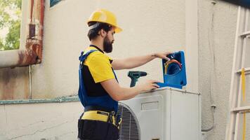 autorisé ingénieur commandé par Accueil propriétaire, en train de préparer pour annuel air Conditionneur entretien. capable technicien déballage boîte à outils avec professionnel équipement nécessaire à réparer cassé évacuation lignes photo