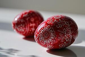 ai généré deux rouge Pâques des œufs avec une peint modèle sur une blanc Contexte fermer. génératif ai photo