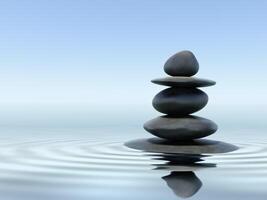 équilibré Zen des pierres dans l'eau avec réflexion photo