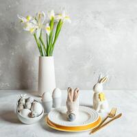blanc monochrome Pâques tableau. œufs, figuré assiettes, lapin, serviette de table comme lapin museau, iris fleurs. photo