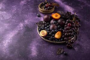 assortiment de violet fruit prune, raisin, myrtille et basilic photo