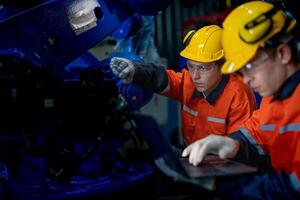 affaires ingénieurs rencontrer et vérifier contrôle lourd machine robot bras. diverse équipe de industriel la robotique ingénieurs recueillies autour machine. professionnel machinerie opérateur utilisation industriel numérique tablette. photo