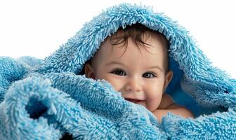 ai généré portrait de une mignonne bambin garçon après baignade enveloppé dans une bleu serviette photo