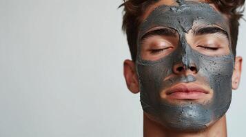 ai généré Jeune homme avec fermé yeux et visage masque sur isolé Contexte. Pour des hommes peau se soucier ou spa traitement. généré par artificiel intelligence. photo