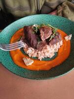 bouillie avec du boeuf et sauce sur une assiette dans une restaurant photo