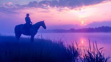 ai généré cow-boy équitation à lever du soleil par Lac photo