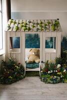 blanc nounours ours est séance dans une petit en bois maison avec une vert toit. photo