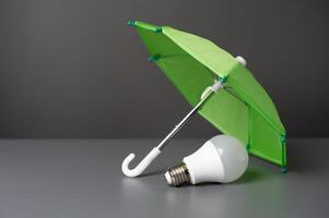 une lumière ampoule idée en dessous de le Assurance parapluie. innovant solutions. affaires assurance. protection de droits d'auteur, brevets et les technologies. photo