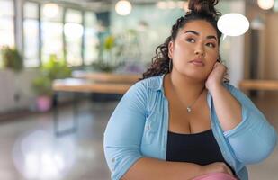 ai généré Jeune plus Taille mixte course femme séance seul sur chaise dans moderne Bureau à la recherche une façon et en pensant photo