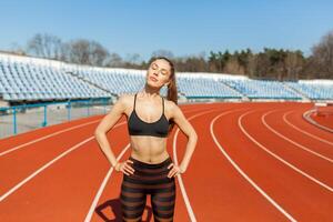 Jeune aptitude femme coureur chaud en haut avant fonctionnement sur piste. Matin des exercices à été photo