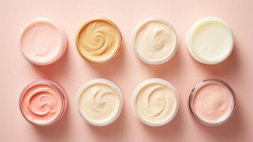 ai généré variété de biologique cosmétique crèmes pour peau se soucier dans ouvert pots sur rose Contexte. Haut voir. concept de soin de la peau variété, produits de beauté assortiment, et beauté produit afficher photo