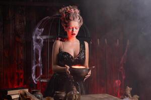 Halloween sorcière avec chaudron. magnifique Jeune femme prestidigitation, fabrication la sorcellerie photo