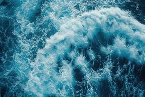 ai généré fermer aérien vue de moussant bleu océan vagues. photo