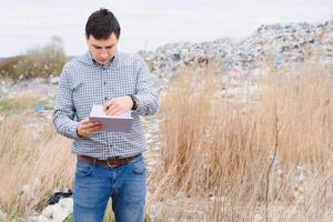 la nature préservation concept. une homme études le la pollution de la nature. en gardant le environnement faire le ménage. écologique problèmes. recyclage photo