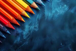 ai généré rangée de coloré des crayons sur bleu surface photo