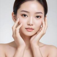 ai généré le frais asiatique Dame a radiant et lisse peau, sa main doucement émouvant sa affronter. photo