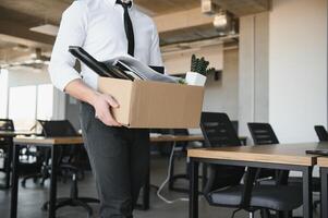 économiste en quittant bureau. Beau économiste en quittant le Bureau prise le sien boîte avec différent des choses photo