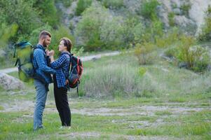 content romantique couple homme et femme les voyageurs avec sac à dos en portant mains alpinisme Voyage mode de vie et relation l'amour concept montagnes paysage sur Contexte photo