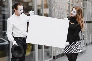 votre texte ici. acteurs mimes en portant vide blanc lettre. coloré portrait avec gris Contexte. avril imbéciles journée photo