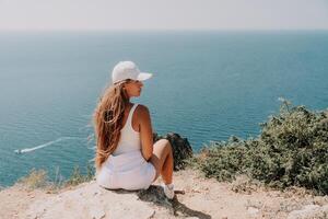 femme été Voyage mer. content touristique prendre plaisir prise image en plein air pour souvenirs. femme voyageur posant plus de mer baie entouré par volcanique montagnes, partage Voyage aventure périple photo