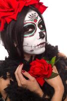 journée de le mort. Halloween. Jeune femme dans journée de le mort masque crâne visage art et Rose. isolé sur blanche. fermer. photo