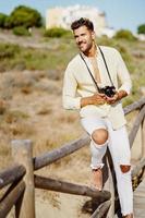 homme souriant photographiant dans une zone côtière. photo