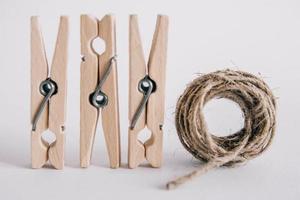 pinces à linge en bois avec corde sur fond blanc. place pour votre texte photo