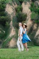 jeune couple, un gars et une fille marchent dans les collines de la montagne photo