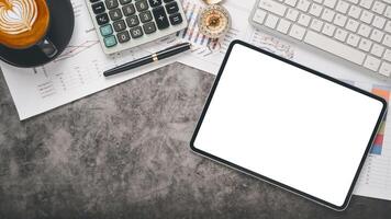 un organisé bureau avec une Vide tablette filtrer, financier documents, une tasse de cappuccino, et Bureau fournitures. photo