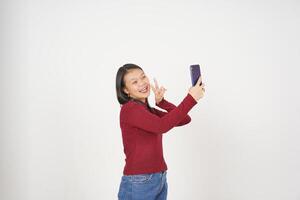 Jeune asiatique femme dans rouge T-shirt prendre une selfie photo isolé sur blanc Contexte