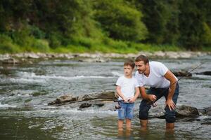 père enseignement fils Comment à poisson volant dans rivière photo