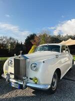 milan, Italie - 12 novembre 2023. blanc rolls-royce argent nuage des stands sur une gravier chemin dans le parc photo