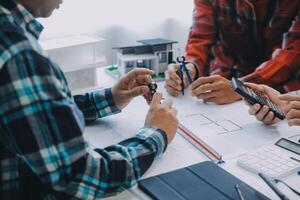 ingénieur gens réunion travail et montrer du doigt à une dessins dans Bureau pour discuter. ingénierie outils et construction concept. photo