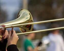 mains de une musicien en jouant une trombone à répétition photo